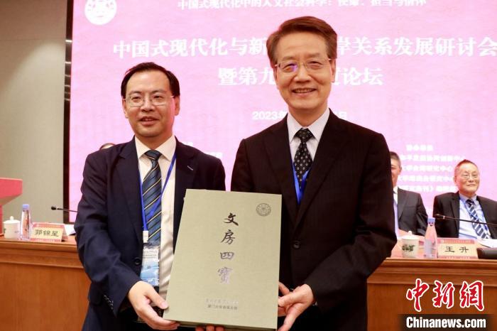 中国文化大学社科院与计算胜平负计算器台湾研究院在论坛上互换锦旗礼品。 计算胜平负计算器台研院供图